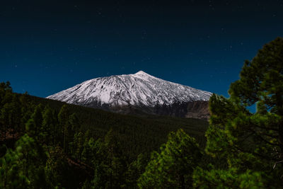 View of volcanic landscape against star field