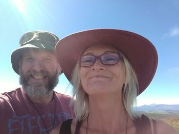 Portrait of smiling man wearing sunglasses against sky