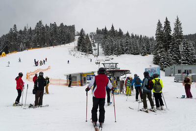 Group of people skiing on snow field