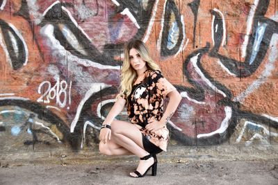 Portrait of woman with graffiti on wall
