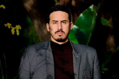 Portrait of man wearing suit while standing outdoors