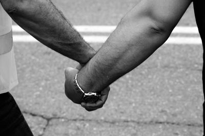 Low section of man holding hands