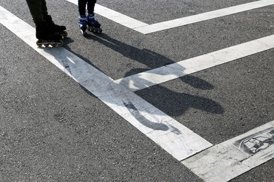 Low section of person walking on road