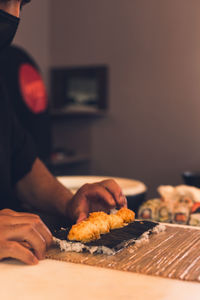 Midsection of man with food on table