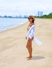 Portrait of young woman standing on beach