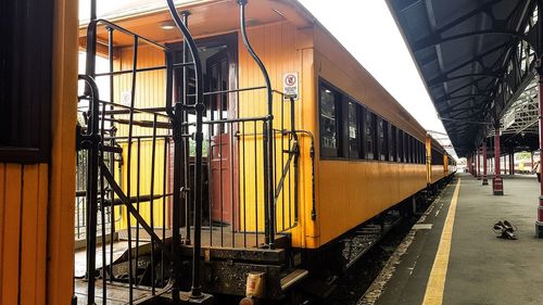 Train on street amidst buildings in city