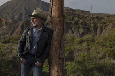 Adult man in cowboy hat in oasis of desert. almeria, spain