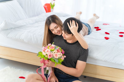 Young woman lying on bed at home