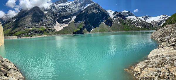 Scenic view of lake and mountains against sky