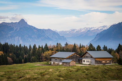 Houses by mountains against sky