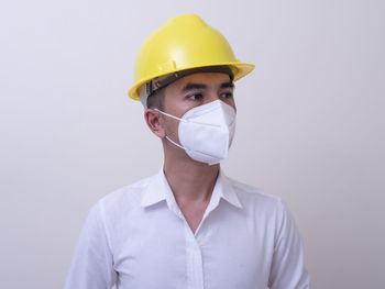 Portrait of man wearing mask against white background