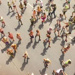 High angle view of people running in marathon on road