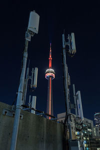 Low angle view of illuminated buildings against sky at night