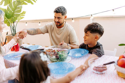 Smiling family celebration. kids and father are happy that food arrived. 