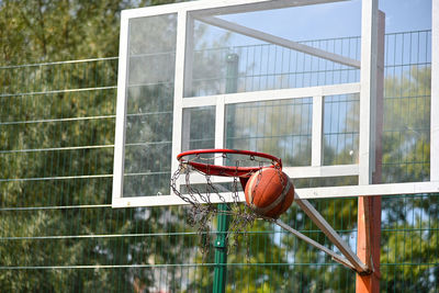 Close-up of basketball hoop against window