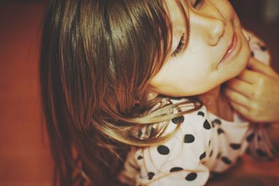 Close-up of cute girl smiling at home