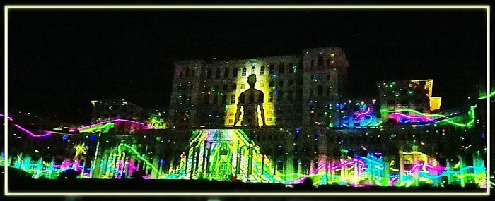 Illuminated fountain against sky
