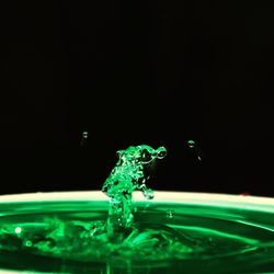 Close-up of water splashing against black background