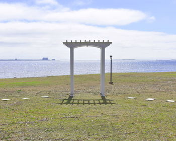 Lifeguard hut at beach against sky