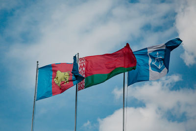 Low angle view of flag flags against sky