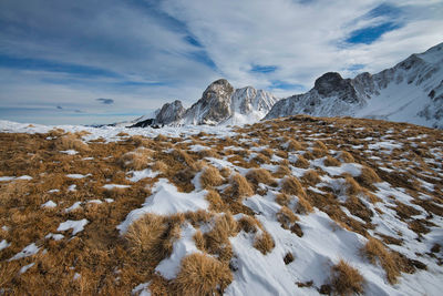 Snow covered landscape against sky