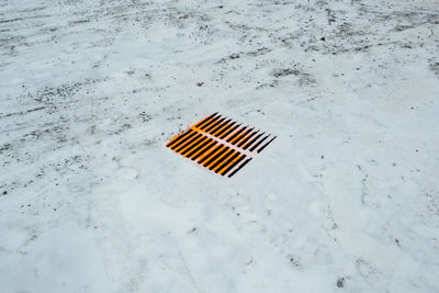 High angle view of snow on manhole