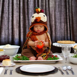 Boy dressed as turkey on plate