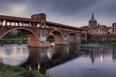 Arch bridge over river in city