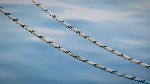 Low angle view of ropes against sky