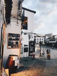 People on street against buildings in city