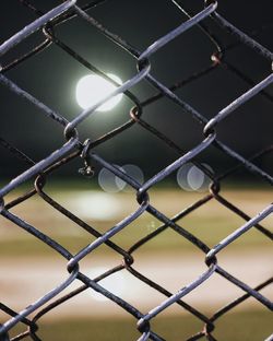 Full frame shot of chainlink fence at night