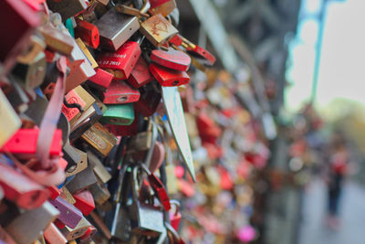 Close-up of padlocks hanging on bridge