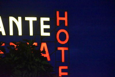 Close-up of illuminated information sign at night