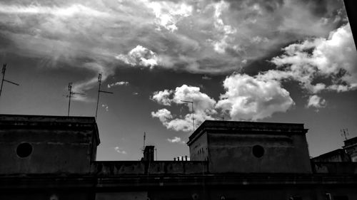 Low angle view of building against cloudy sky