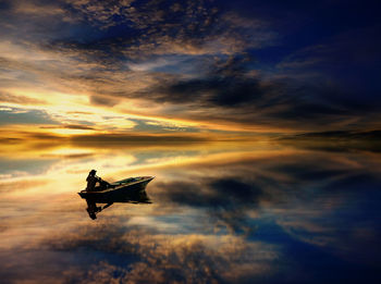 Silhouette person paragliding in sea against sky during sunset