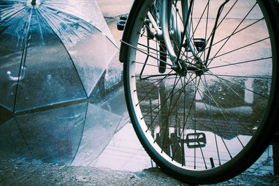 Close-up of bicycle wheel against wall