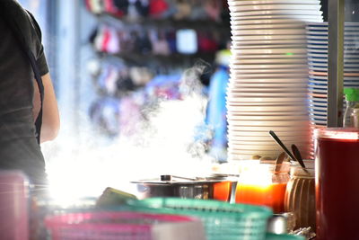 Midsection of woman preparing food in kitchen