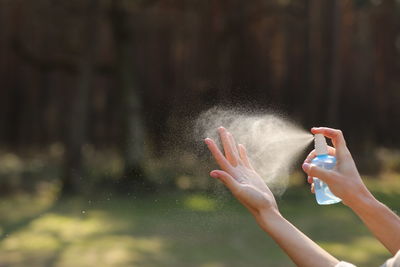 Cropped hands of woman using mobile phone