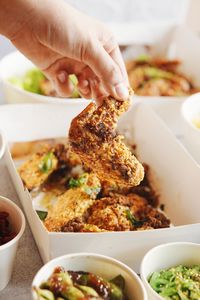 Close-up of hand holding food on table