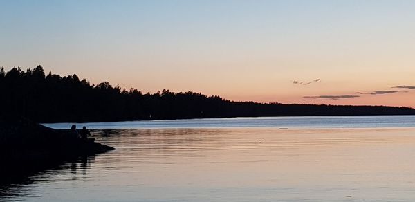 Scenic view of lake against sky during sunset