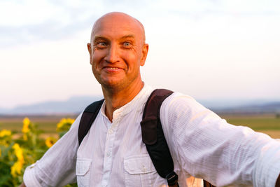 Close-up of a cheerful young man in a white t-shirt