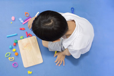 High angle view of boy playing with toys at home