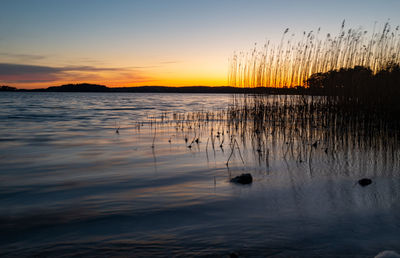 Scenic view of lake against sky during sunset