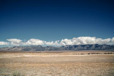 Scenic view of desert against blue sky