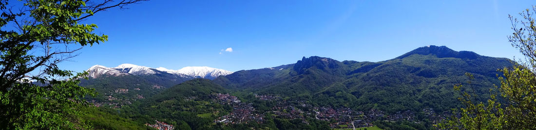 Scenic view of mountains against blue sky