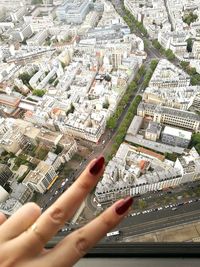 Close-up of hand holding cityscape