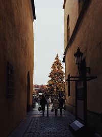 People on street in city against sky