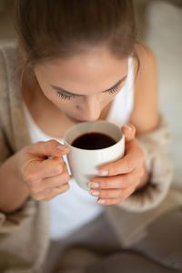 Midsection of man holding coffee cup