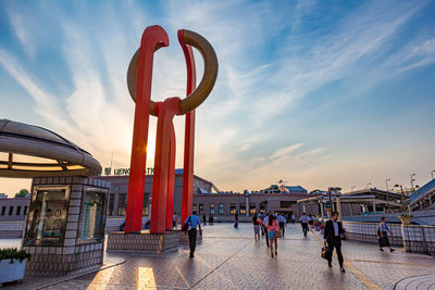 Red sculpture art piece. on the sky walkway in ueno, japan during sunset 