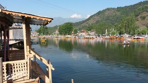 Scenic view of lake by buildings against sky